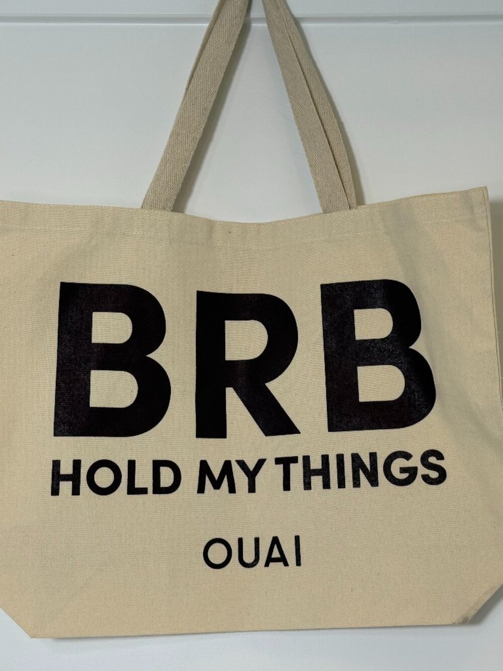 OUAI Haircare "BRB Hold My Things" Canvas Tote Bag Cream Black Logo